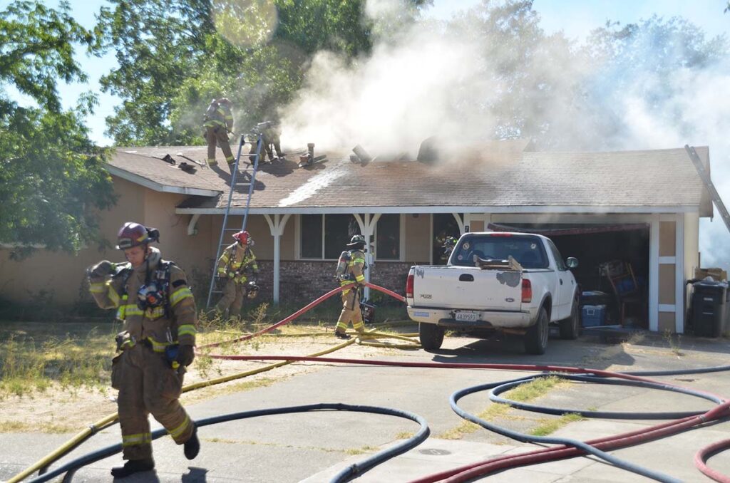 firefighters dealing with smoke coming out from the roof on a home in Bryan TX