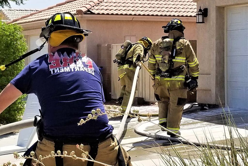 fire fighters respond to a garage house fire