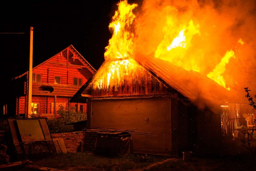 wooden house burning in the middle of the night