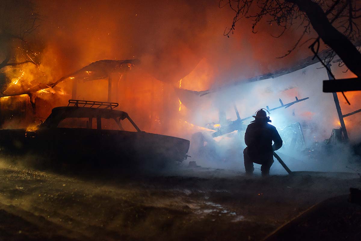 firefighter putting out a house fire